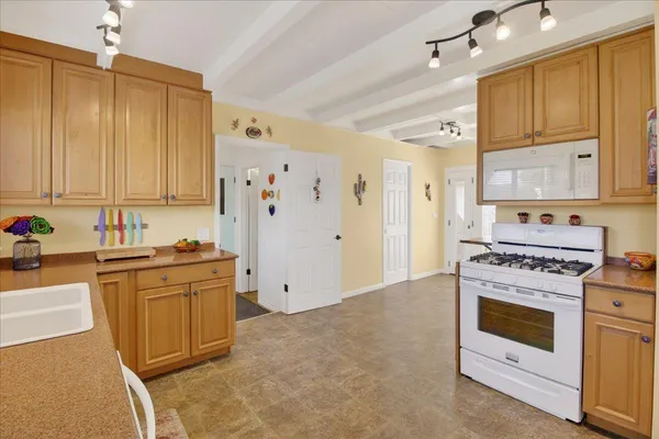 a kitchen with stainless steel appliances granite countertop a stove and a refrigerator