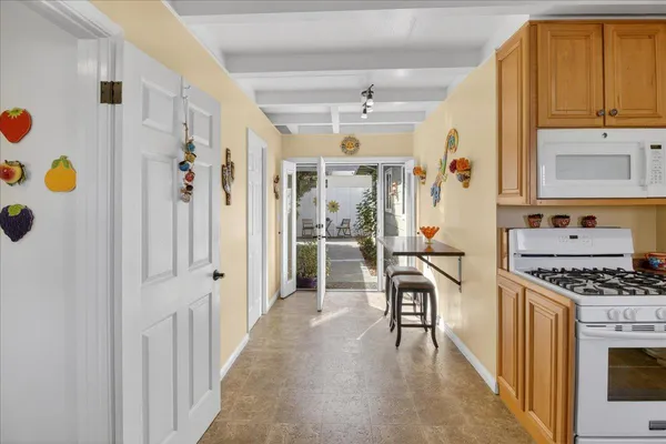 a kitchen with stainless steel appliances granite countertop a refrigerator and a stove top oven