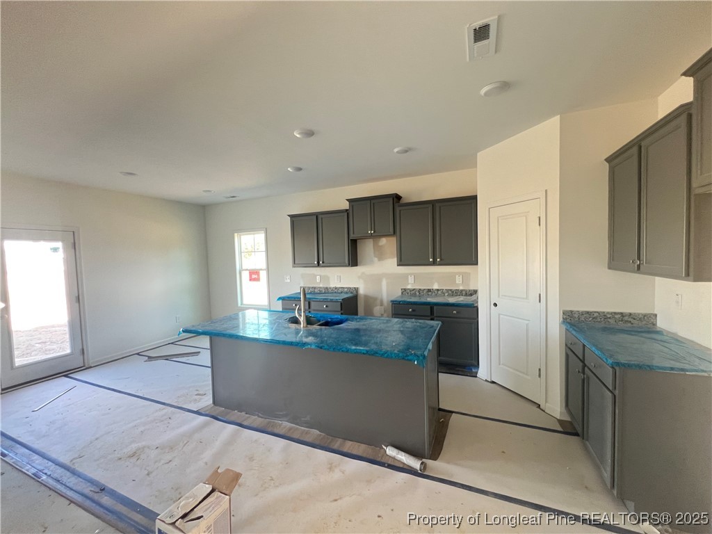 415 Traveller Way Raeford, NC 28376 - Photo 2 of 18 a kitchen with stainless steel appliances granite countertop a refrigerator and a stove top oven