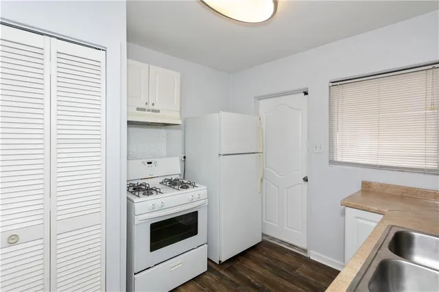 a kitchen with a stove and a microwave
