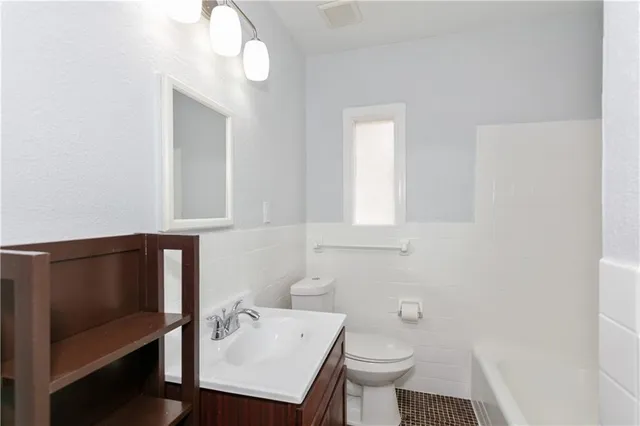 a bathroom with a sink a toilet and vanity
