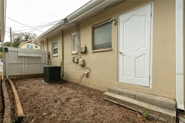 a view of a house with a wooden fence