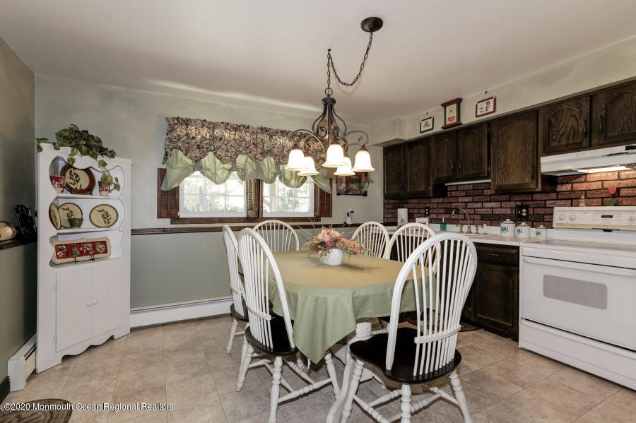 356 Cherry Quay Road Brick, NJ 08723 - Photo 21 of 31 a dining room with furniture a chandelier and window