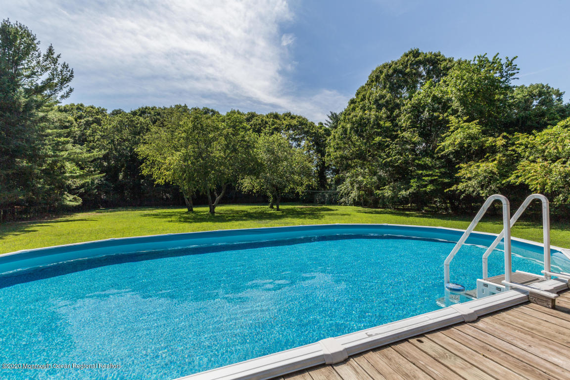 356 Cherry Quay Road Brick, NJ 08723 - Photo 27 of 31 a view of a swimming pool is middle in the middle of a lake