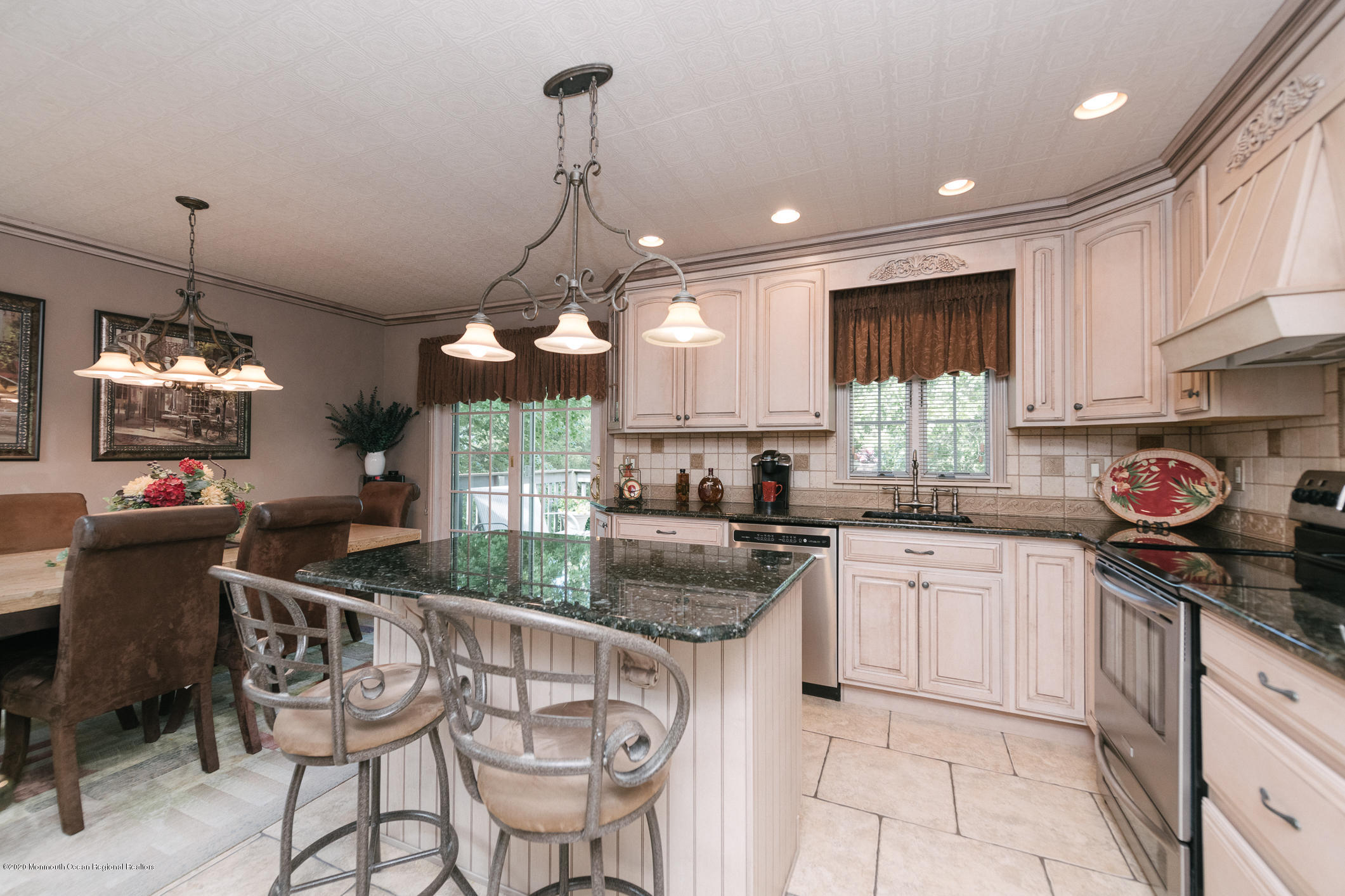 356 Cherry Quay Road Brick, NJ 08723 - Photo 8 of 31 a kitchen with stainless steel appliances granite countertop a sink a stove a refrigerator cabinets and chairs