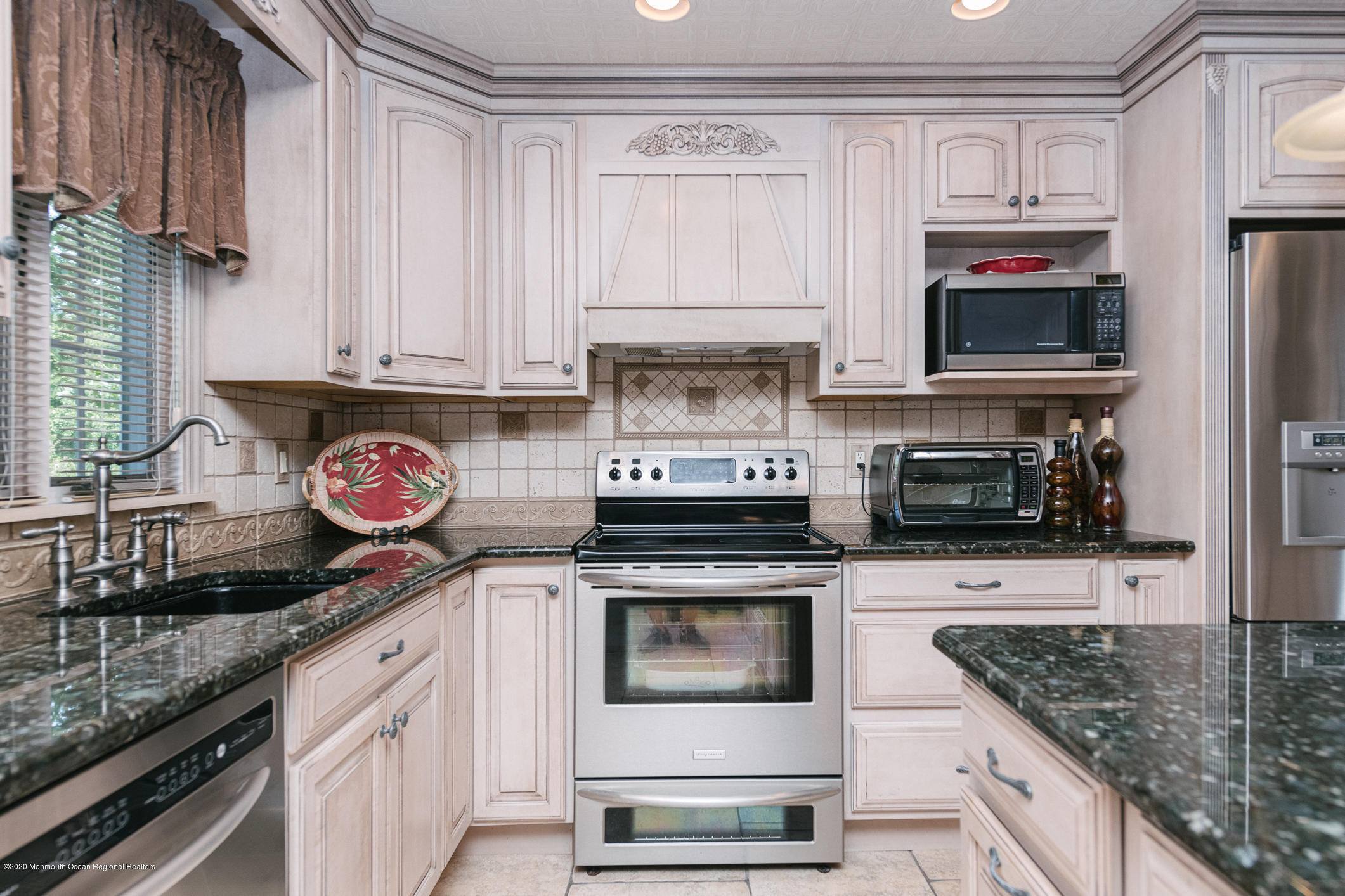 356 Cherry Quay Road Brick, NJ 08723 - Photo 9 of 31 a kitchen with granite countertop a stove top oven microwave and cabinets