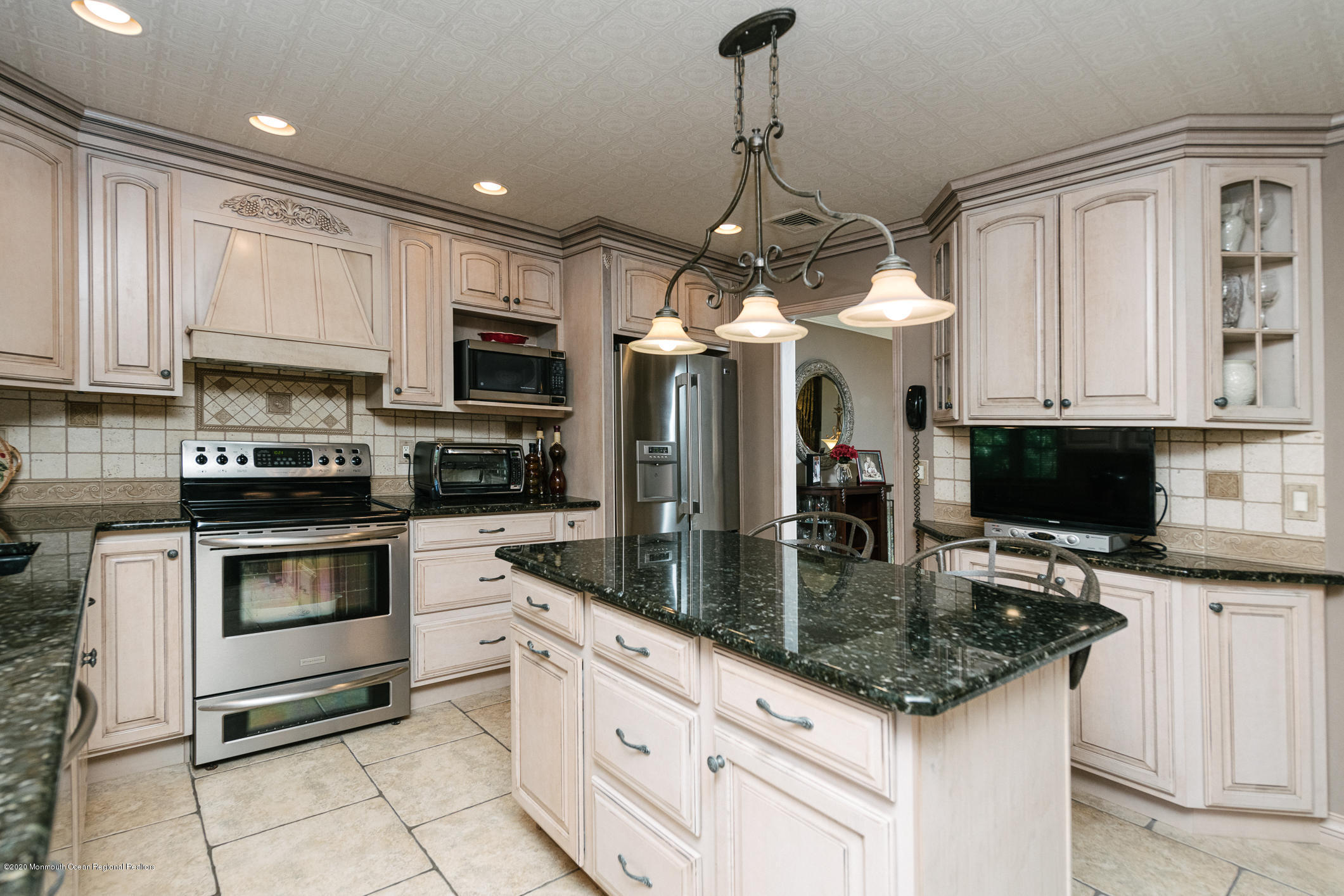 356 Cherry Quay Road Brick, NJ 08723 - Photo 10 of 31 a kitchen with granite countertop a sink stainless steel appliances and white cabinets