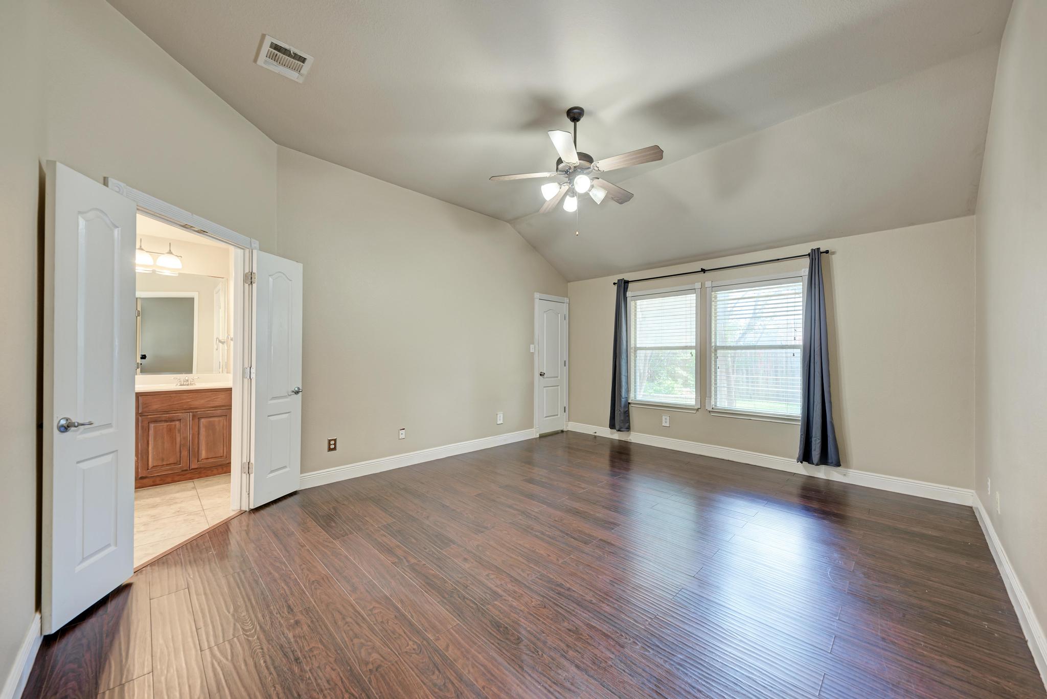 18308 Shallow Pool Drive Pflugerville, TX 78660 - Photo 17 of 40 Primary bedroom with recent painting. Door in the corner leads to one of two primary closets.