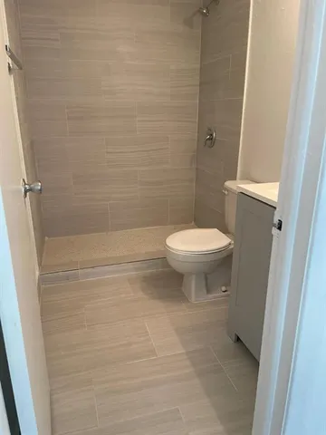 a bathroom with a toilet and a shower