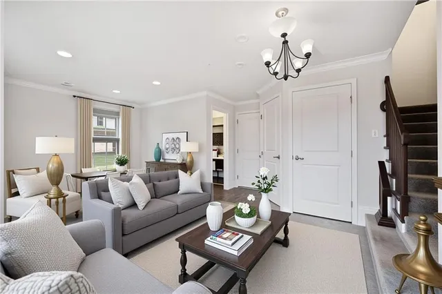 a living room with furniture a chandelier and a window