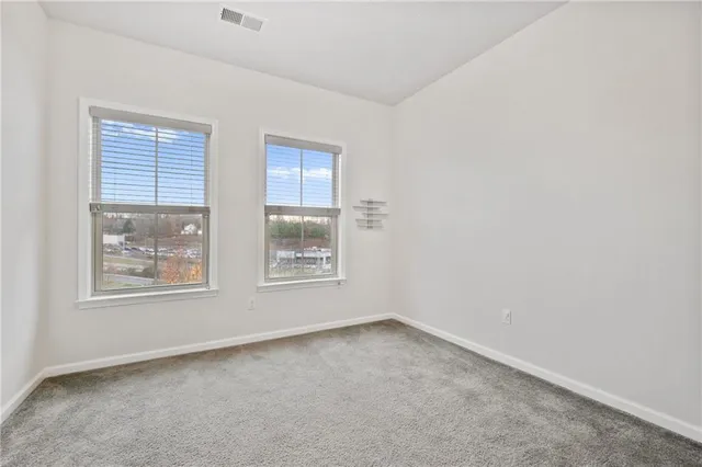 a bathroom with a sink a toilet a mirror a vanity and shower