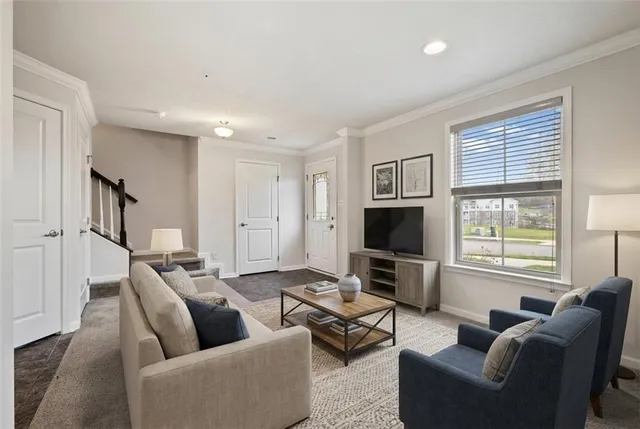 a living room with furniture flat screen tv and a window