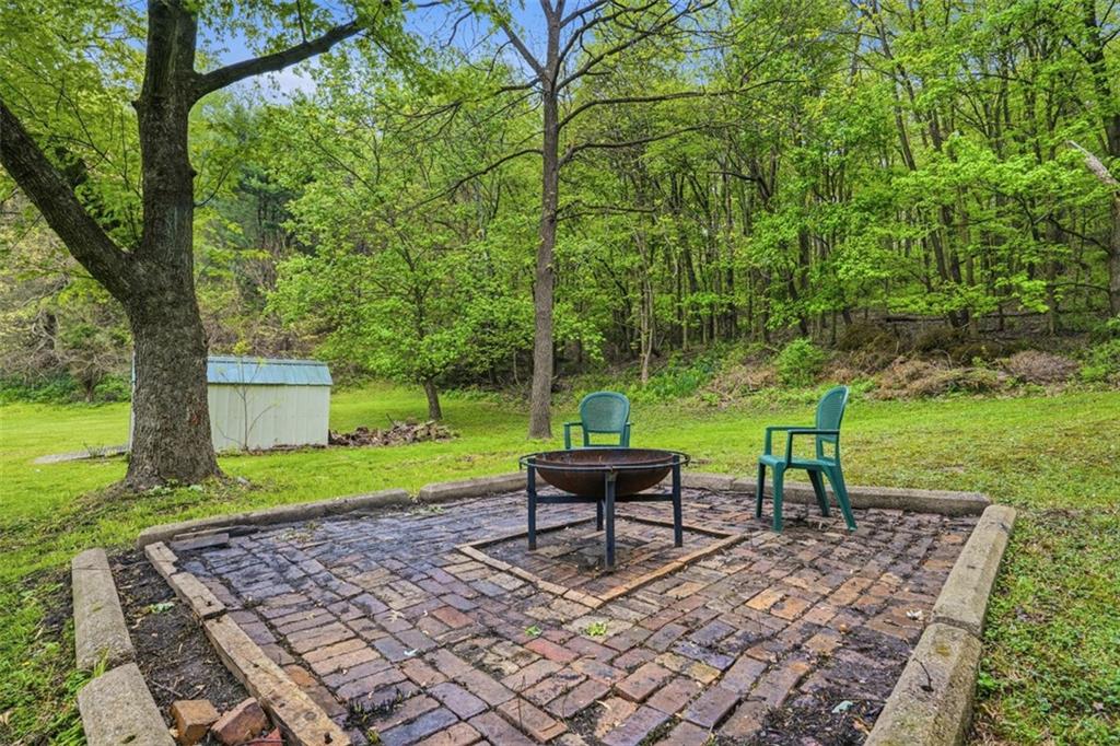 246 Highland Road Rochester, PA 15074 - Photo 36 of 44 a view of a garden with a bench in a garden
