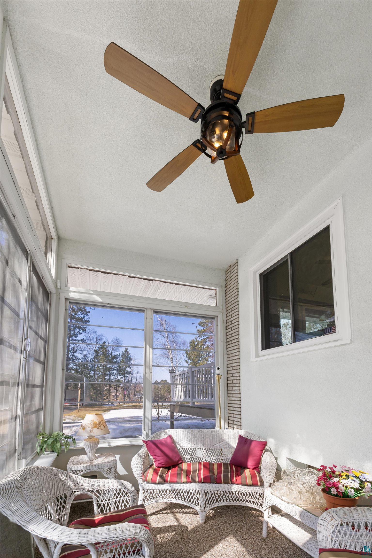 3975 Long Lake Shores Road Eveleth, MN 55734 - Photo 14 of 84 Sunroom / solarium featuring ceiling fan and outdoor furniture