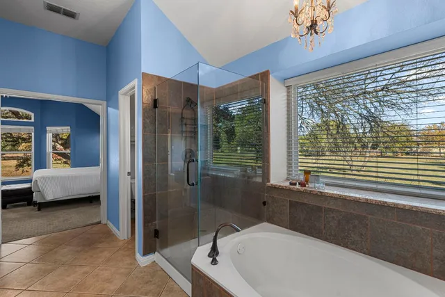 a bathroom with a bathtub and a shower