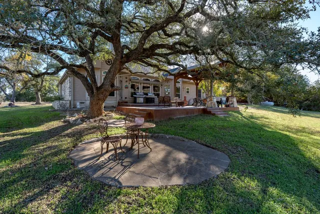 a view of a park with bench and trees