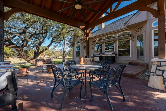 a view of a patio with table and chairs and potted plants