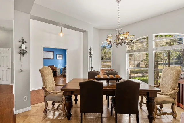 a dining room with furniture a chandelier and a rug