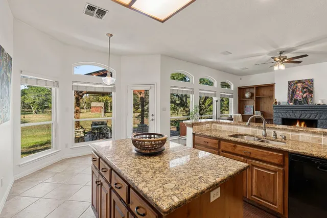 a kitchen with stainless steel appliances granite countertop a sink and a stove