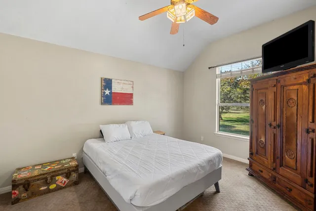 a bedroom with a bed and a flat screen tv