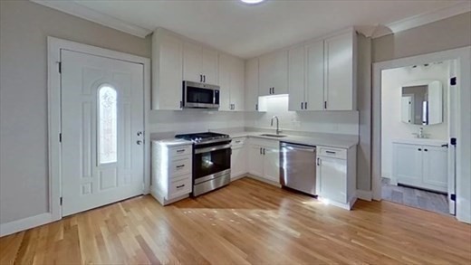 5-7 Hemman Street Boston, MA 02131 - Photo 3 of 11 a kitchen with stainless steel appliances granite countertop a stove a sink and a refrigerator