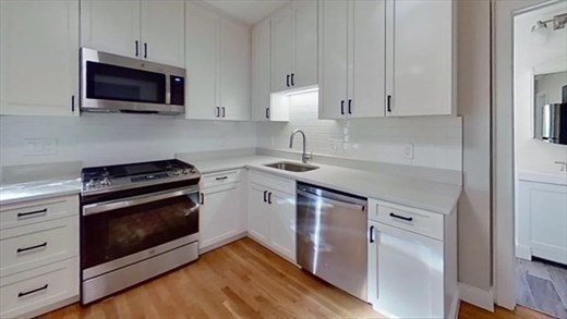 5-7 Hemman Street Boston, MA 02131 - Photo 4 of 11 a kitchen with stainless steel appliances a stove microwave and sink