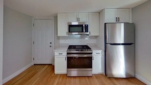 5-7 Hemman Street Boston, MA 02131 - Photo 5 of 11 a kitchen with a stove and a refrigerator