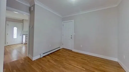 a view of a room with wooden floor