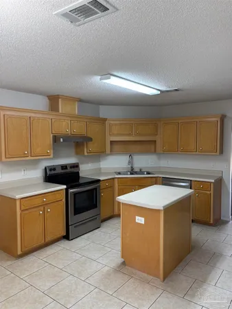 a kitchen with stainless steel appliances granite countertop a sink counter space and cabinets
