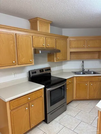 a kitchen with granite countertop cabinets stainless steel appliances and a sink