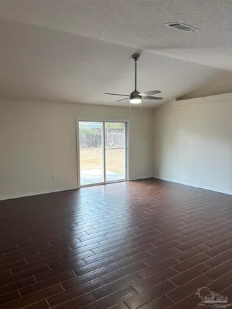 a view of a room with wooden floor