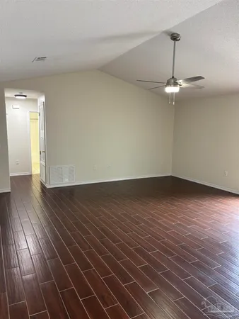 a view of a room with wooden floor staircase and a kitchen