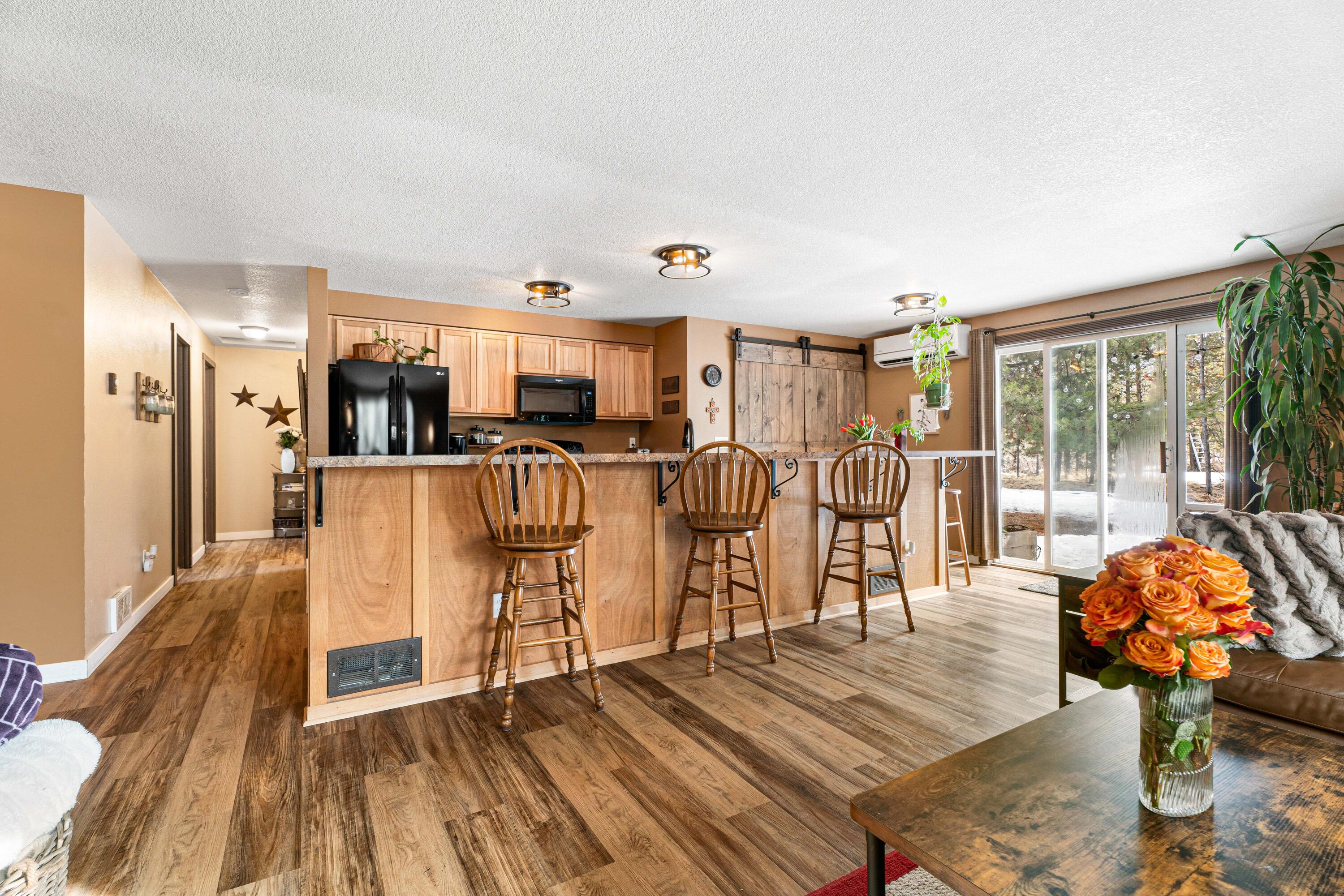 16939 Torrance Road Bend, OR 97707 - Photo 9 of 33 a living room with furniture a wooden floor and next to a window