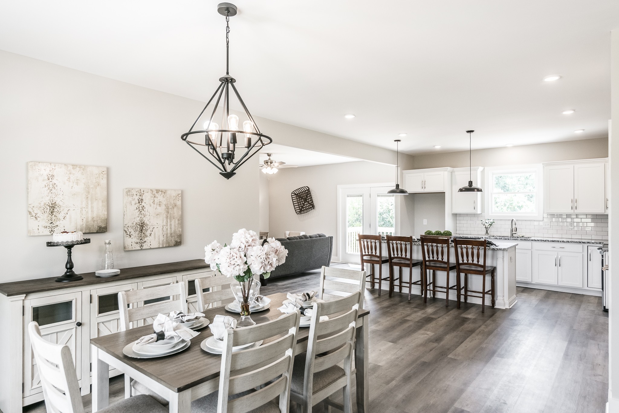 4839 Pulliam-Hardaway Road Springfield, TN 37172 - Photo 21 of 40 a dining room with wooden floor a chandelier a wooden table and chairs