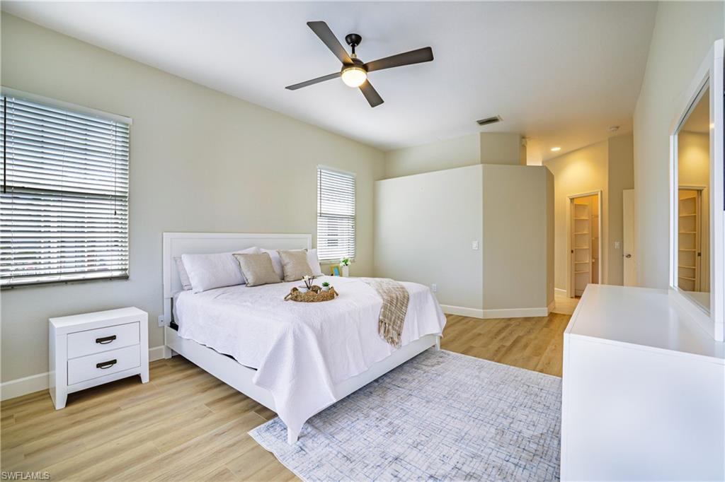 5235 Malvern Court Naples, FL 34112 - Photo 14 of 28 a bedroom with a bed and a couch