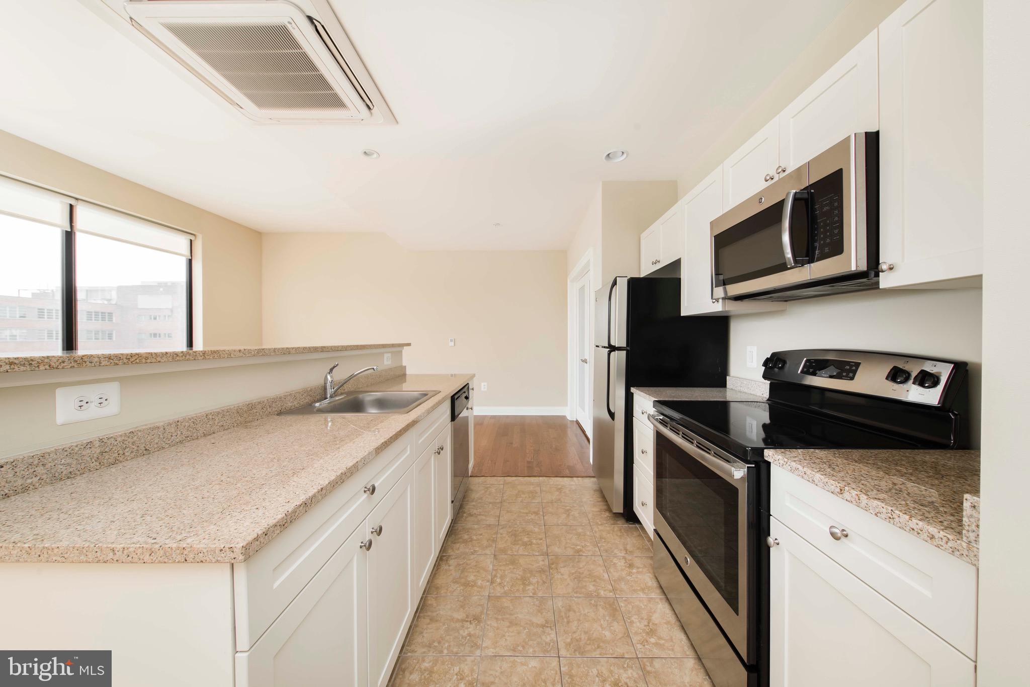 521 St Paul Street, Unit 2BR Baltimore, MD 21202 - Photo 34 of 44 a kitchen with stainless steel appliances granite countertop a sink and a stove