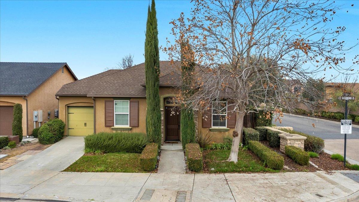 a front view of a house with garden