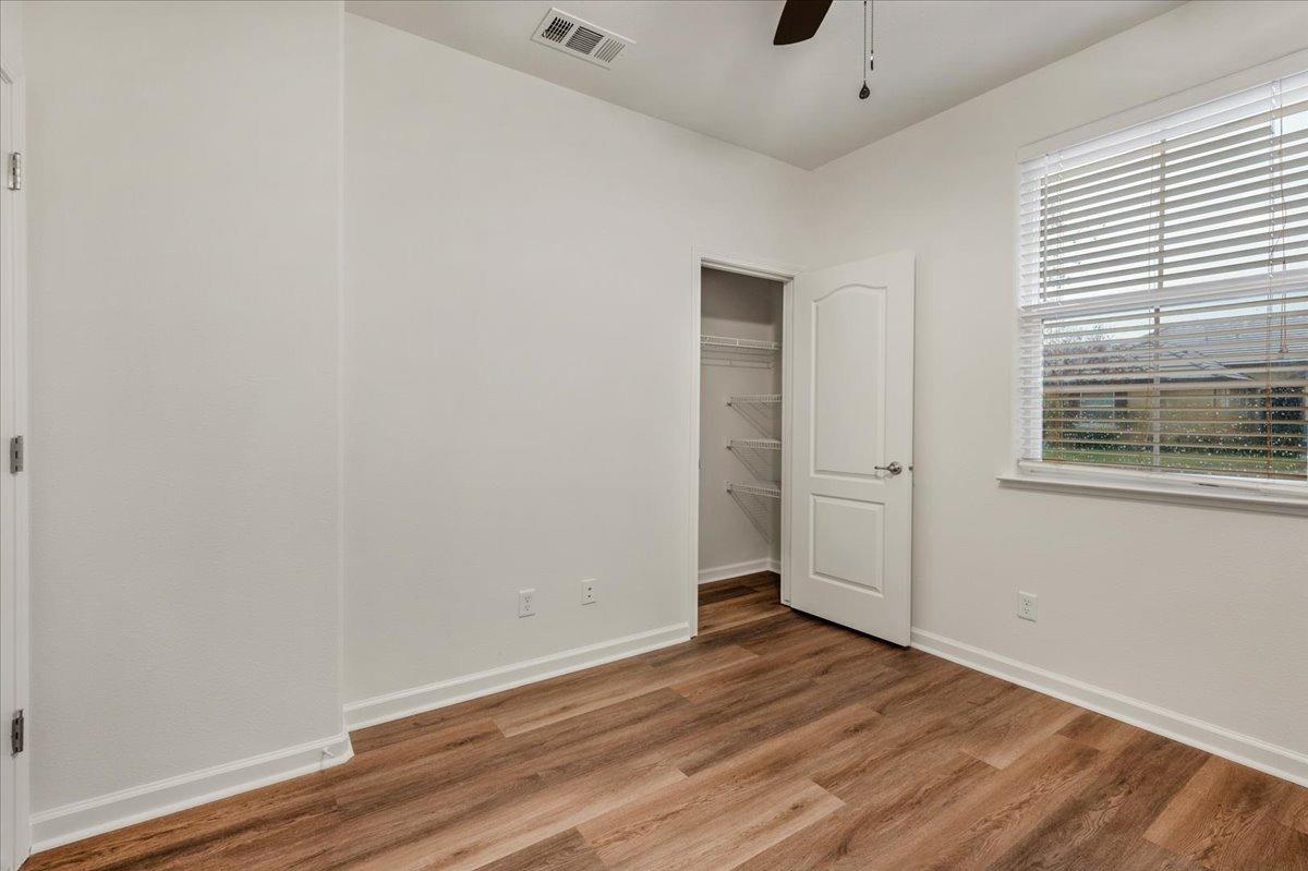 3755 Richmond Avenue Clovis, CA 93619 - Photo 22 of 30 an empty room with wooden floor and windows