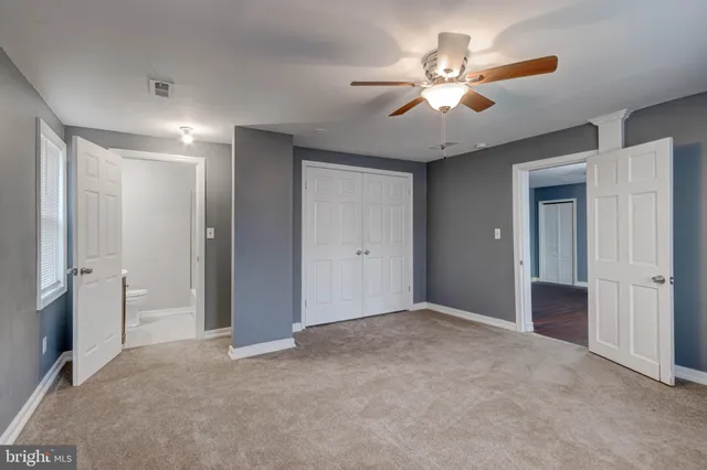 a bathroom with a sink mirror and toilet