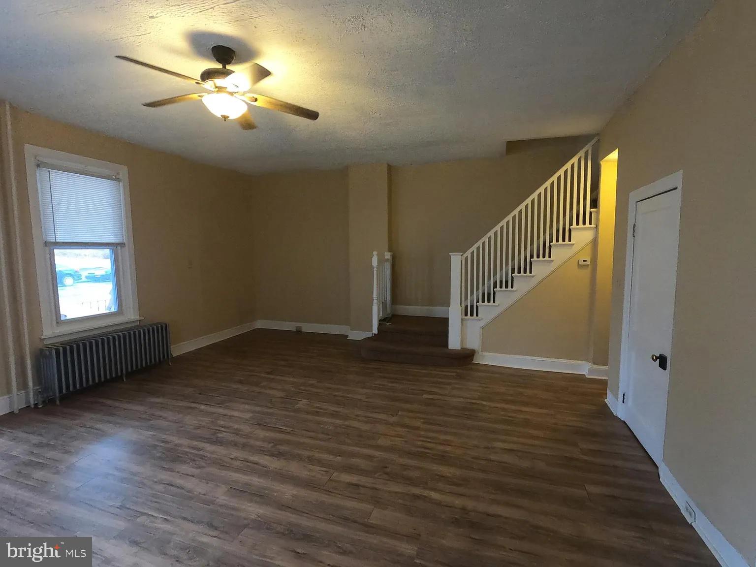 604 East Marshall Street Norristown, PA 19401 - Photo 3 of 11 a view of an empty room with a window and wooden floor