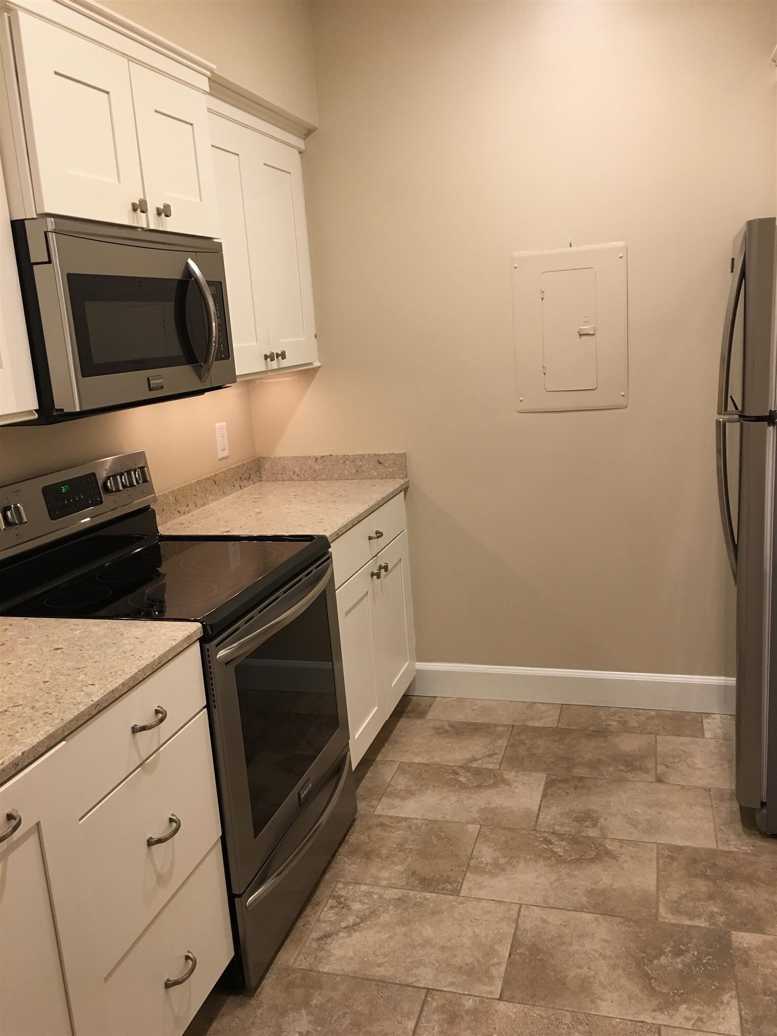 517 Sloan Road Nashville, TN 37209 - Photo 7 of 25 a kitchen with granite countertop a stove and a microwave