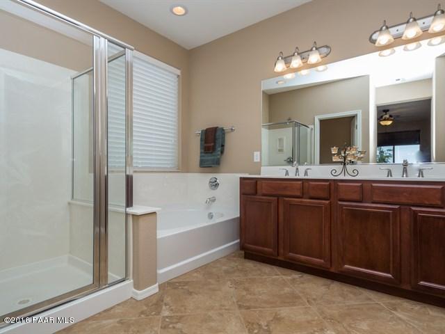 1101 Rusty Nail Road Prescott Valley, AZ 86314 - Photo 8 of 29 a bathroom with a tub a double vanity sink and a mirror