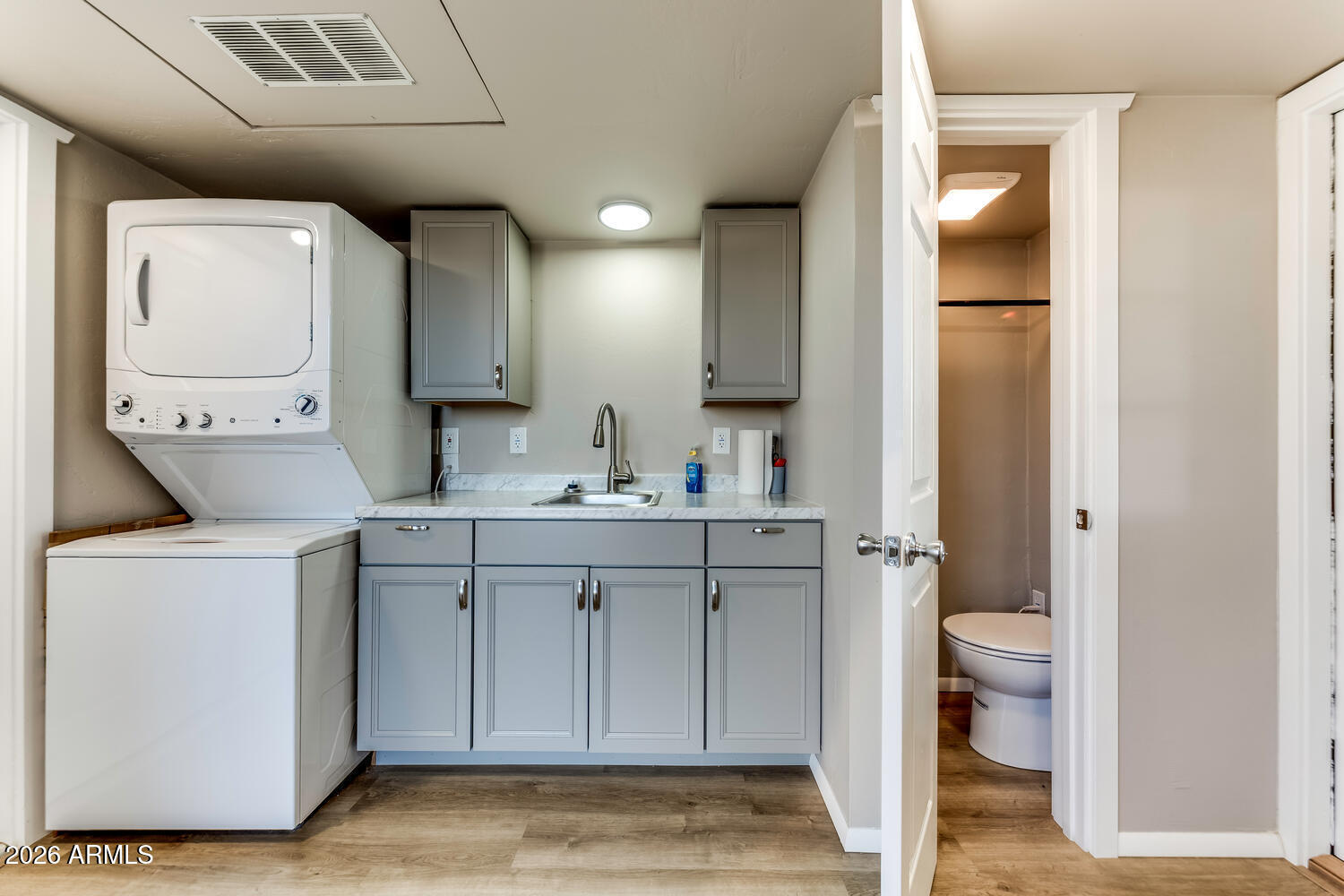 17200 West Bell Road, Unit 722 Surprise, AZ 85374 - Photo 5 of 19 a bathroom with a toilet sink and mirror