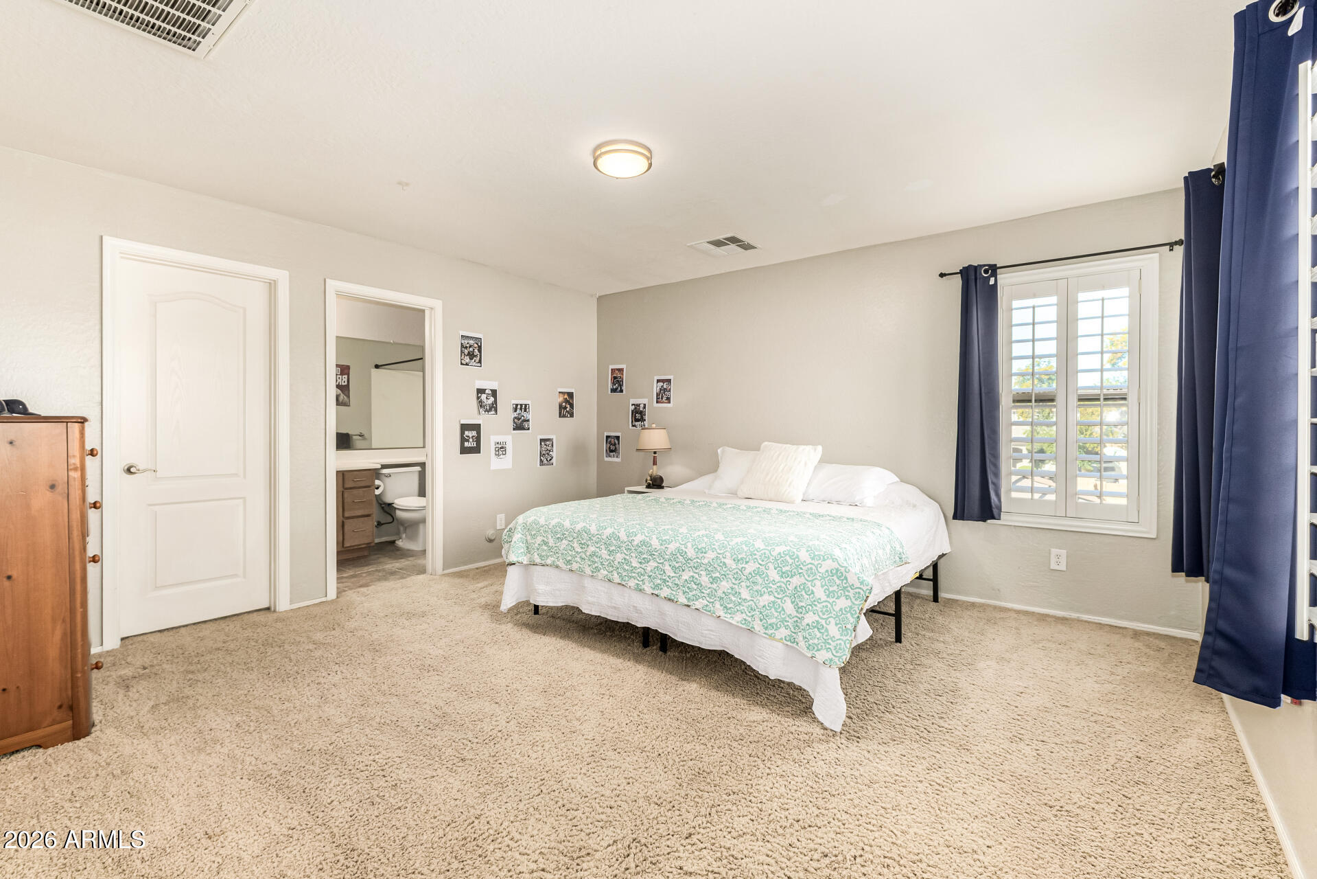 2858 East Shannon Street Gilbert, AZ 85295 - Photo 21 of 35 a spacious bedroom with a bed and a cabinets