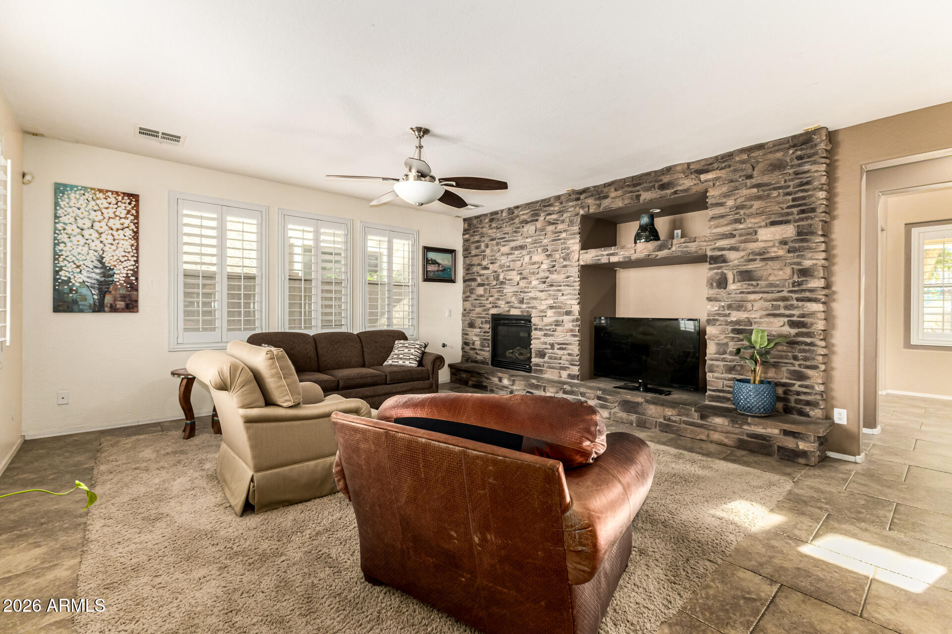 2858 East Shannon Street Gilbert, AZ 85295 - Photo 3 of 35 a living room with fireplace furniture and a fireplace