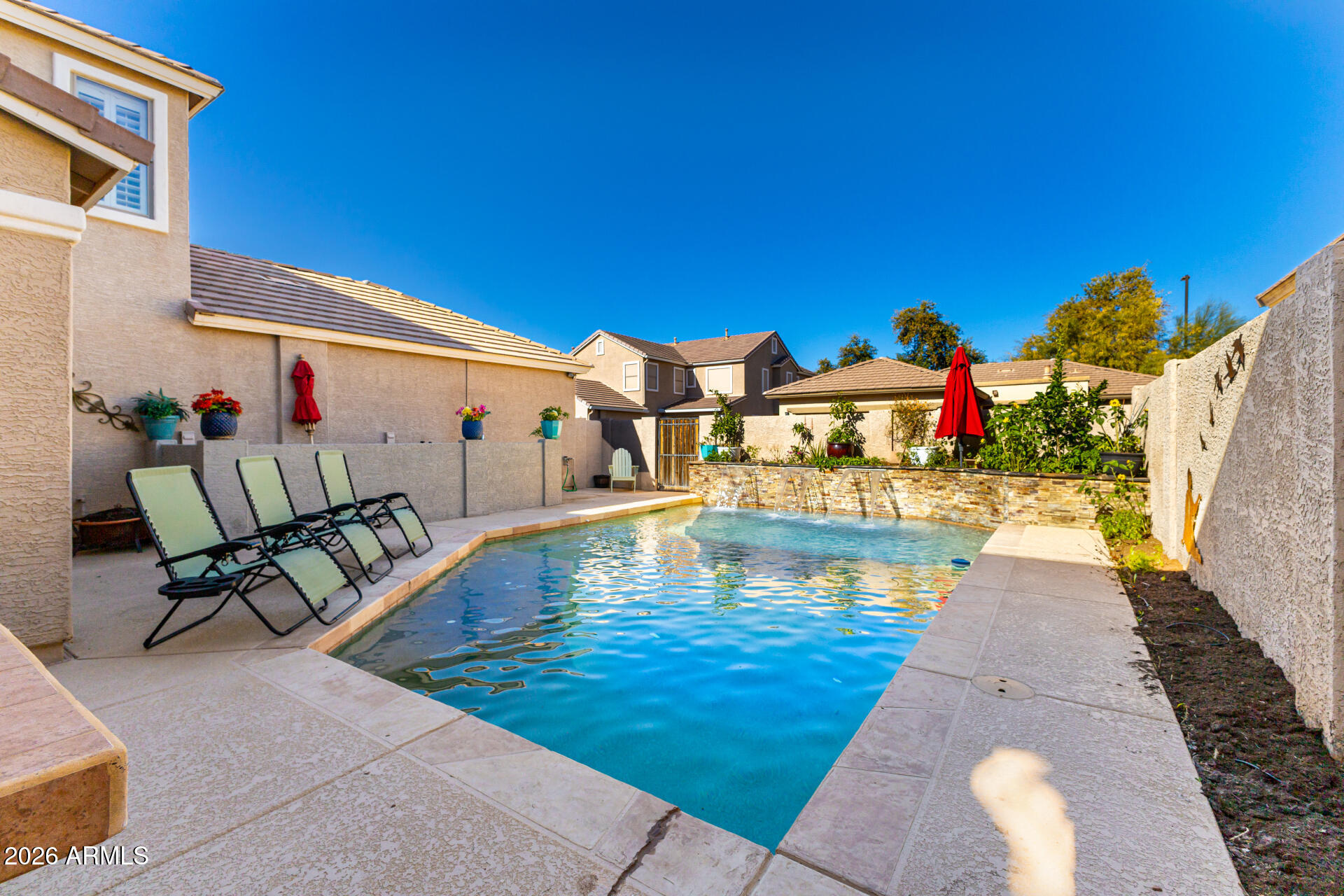 2858 East Shannon Street Gilbert, AZ 85295 - Photo 33 of 35 a view of a swimming pool with a lounge chairs