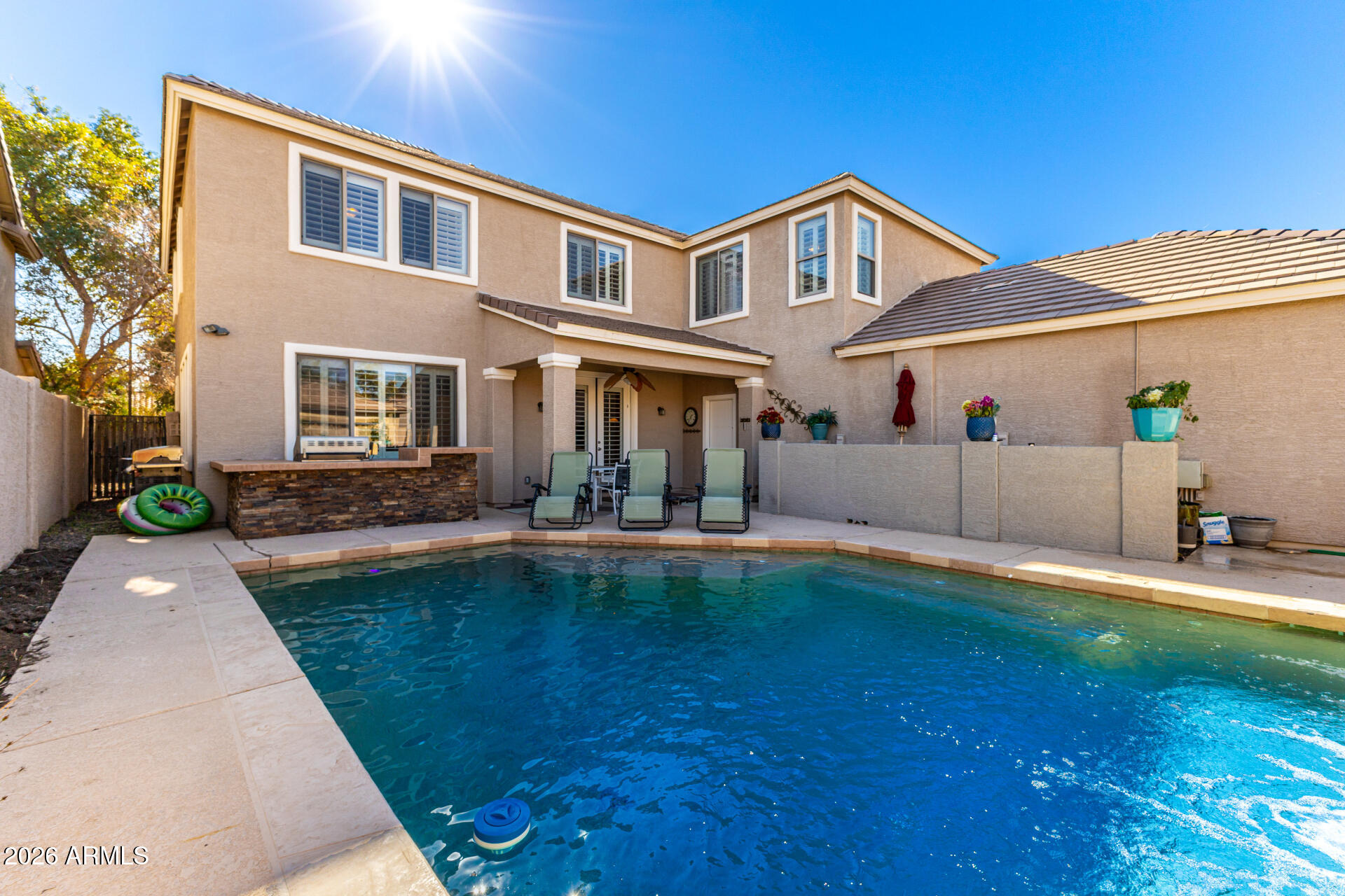 2858 East Shannon Street Gilbert, AZ 85295 - Photo 34 of 35 a front view of a house with swimming pool having outdoor seating