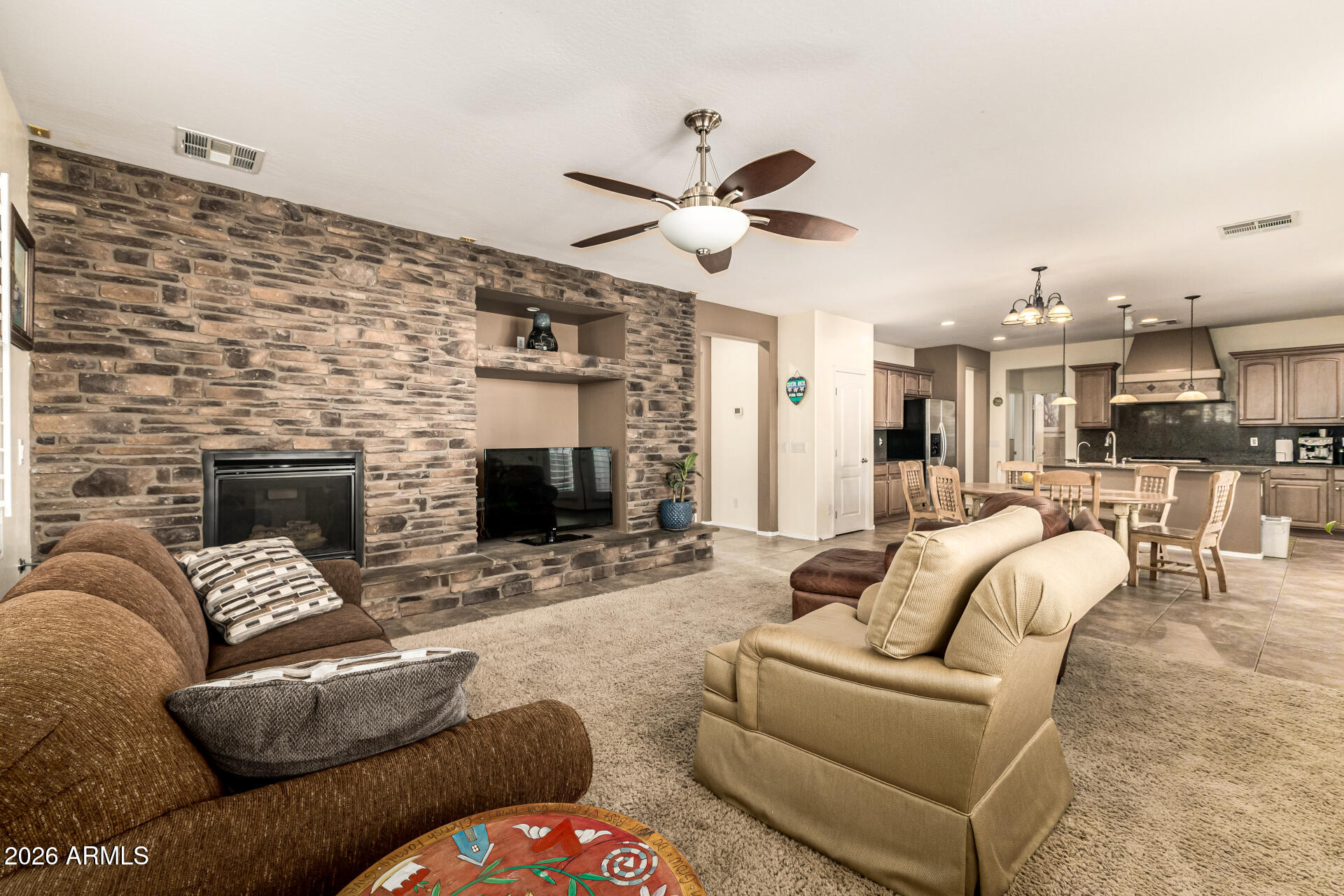 2858 East Shannon Street Gilbert, AZ 85295 - Photo 4 of 35 a living room with furniture and a fireplace