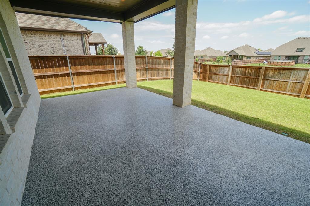 1309 Old Rocksprings Pass Mansfield, TX 76063 - Photo 29 of 36 Covered patio featuring an epoxy-coated concrete floor, brick columns, and a dark wood ceiling with recessed lighting