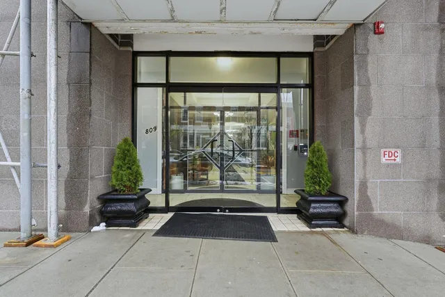 a living room with a large window and plants